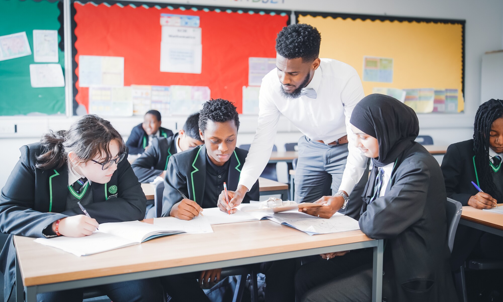 The Stockwood Park Academy Teacher assisting 3 students